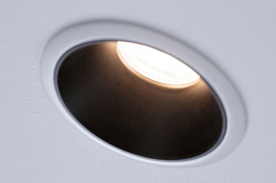 White recessed spotlight with black reflector and warm white LED light for modern indoor lighting