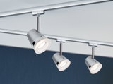 Three silver metal LED spotlights on track system for modern room lighting