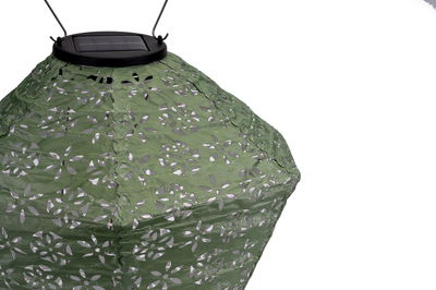 Green fabric solar lantern lampshade with floral cutouts for outdoor lighting and garden decoration