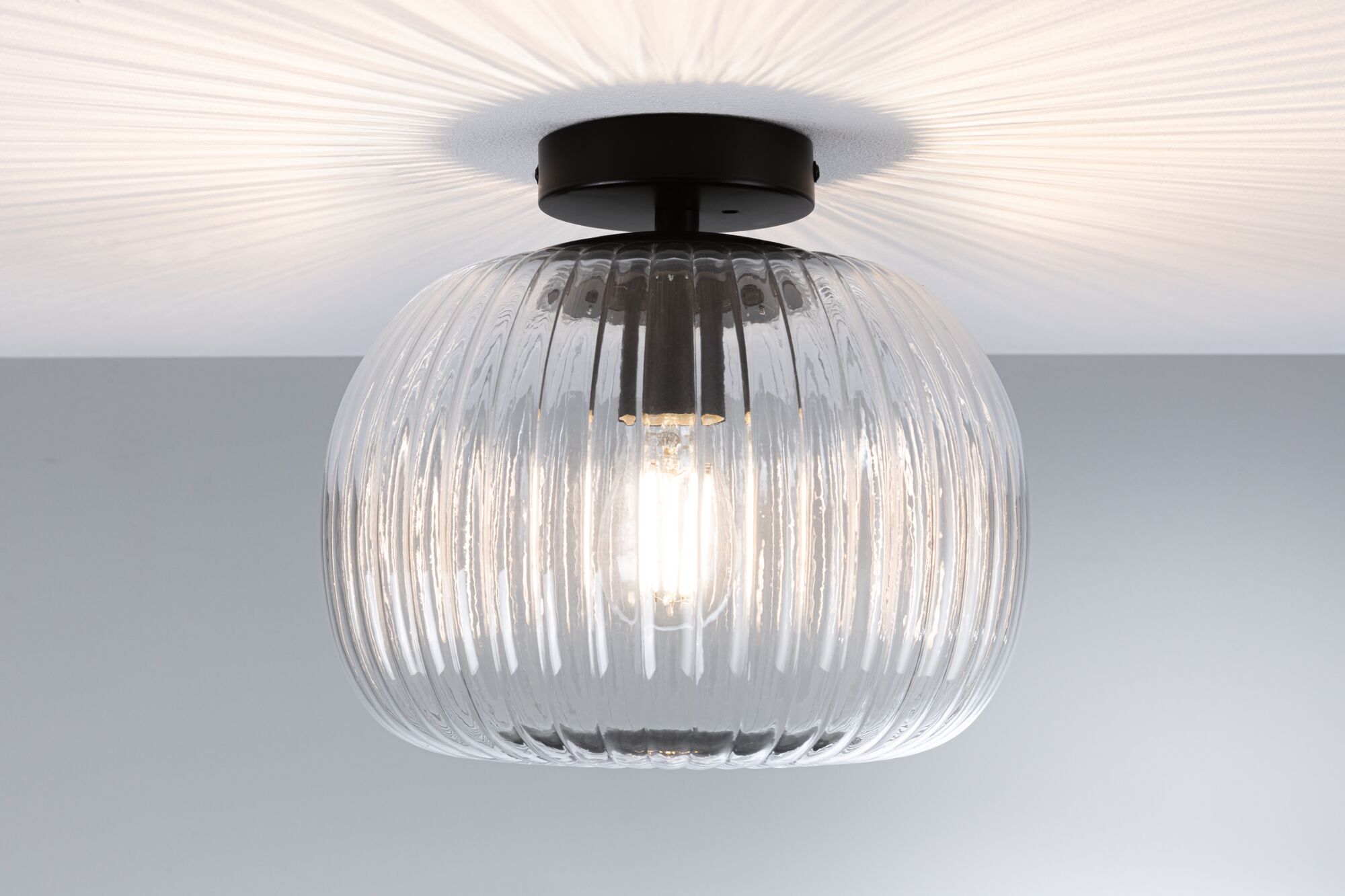 Ceiling light with ribbed clear glass and black metal mount for modern home lighting