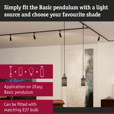 Two black Basic Pendulum pendant lights with metal and glass in modern living room with artwork