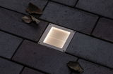 Recessed square LED floor light in stainless steel with warm white glow on dark pavement