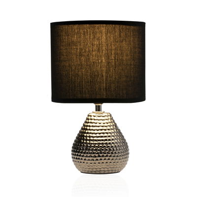 Table lamp with textured gold metal base and black fabric shade for stylish home lighting