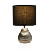 Table lamp with textured gold metal base and black fabric shade for stylish home lighting