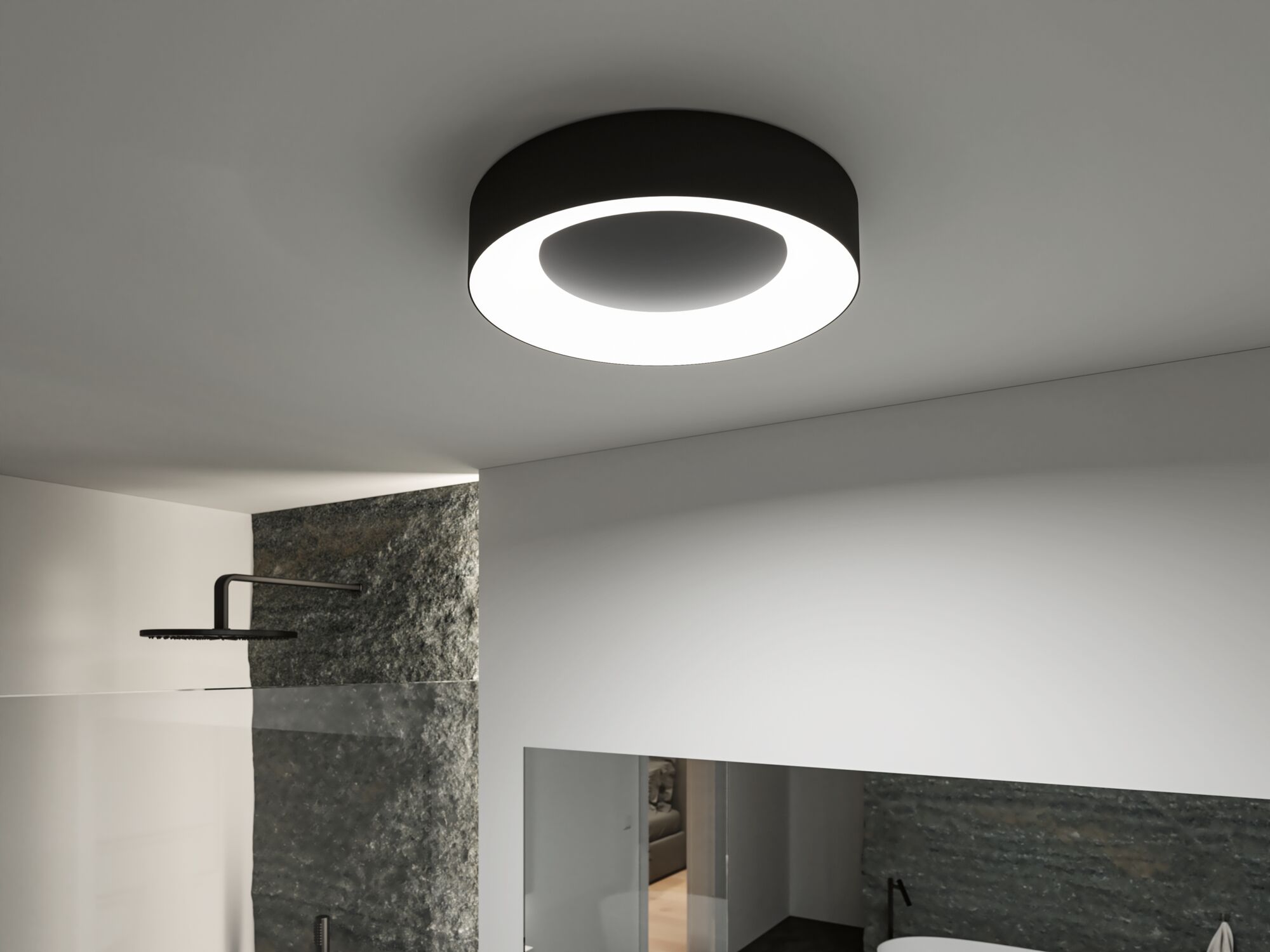 Round ceiling light with black metal housing and bright LED ring in modern bathroom setting.