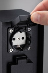 Black plastic socket with protective cover, grounded outlet suitable for outdoor use