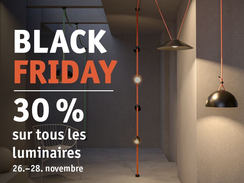 Suspensions noires avec câbles orange sur mur gris dans pièce minimaliste avec chaise et lumière douce