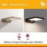 Black solar-powered outdoor wall light with motion sensor and LED for energy-saving garden illumination