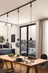 Drei schwarze Pendelleuchten mit Glühfaden-LED über hellem Holztisch im modernen Esszimmer mit Stadtblick