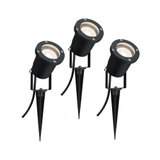 Three black metal LED garden spotlights with ground spikes for outdoor lighting and garden accents