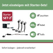 Starter-Set mit schwarzen LED-Gartenleuchten, Kabel und Trafo für einfache Außenbeleuchtung.