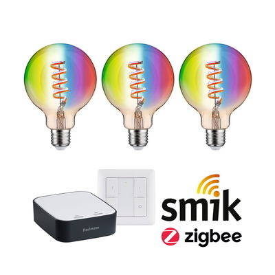 Drie gekleurde LED-lampen met spiraalfilament, slimme bediening en wandschakelaar voor Zigbee-systemen.