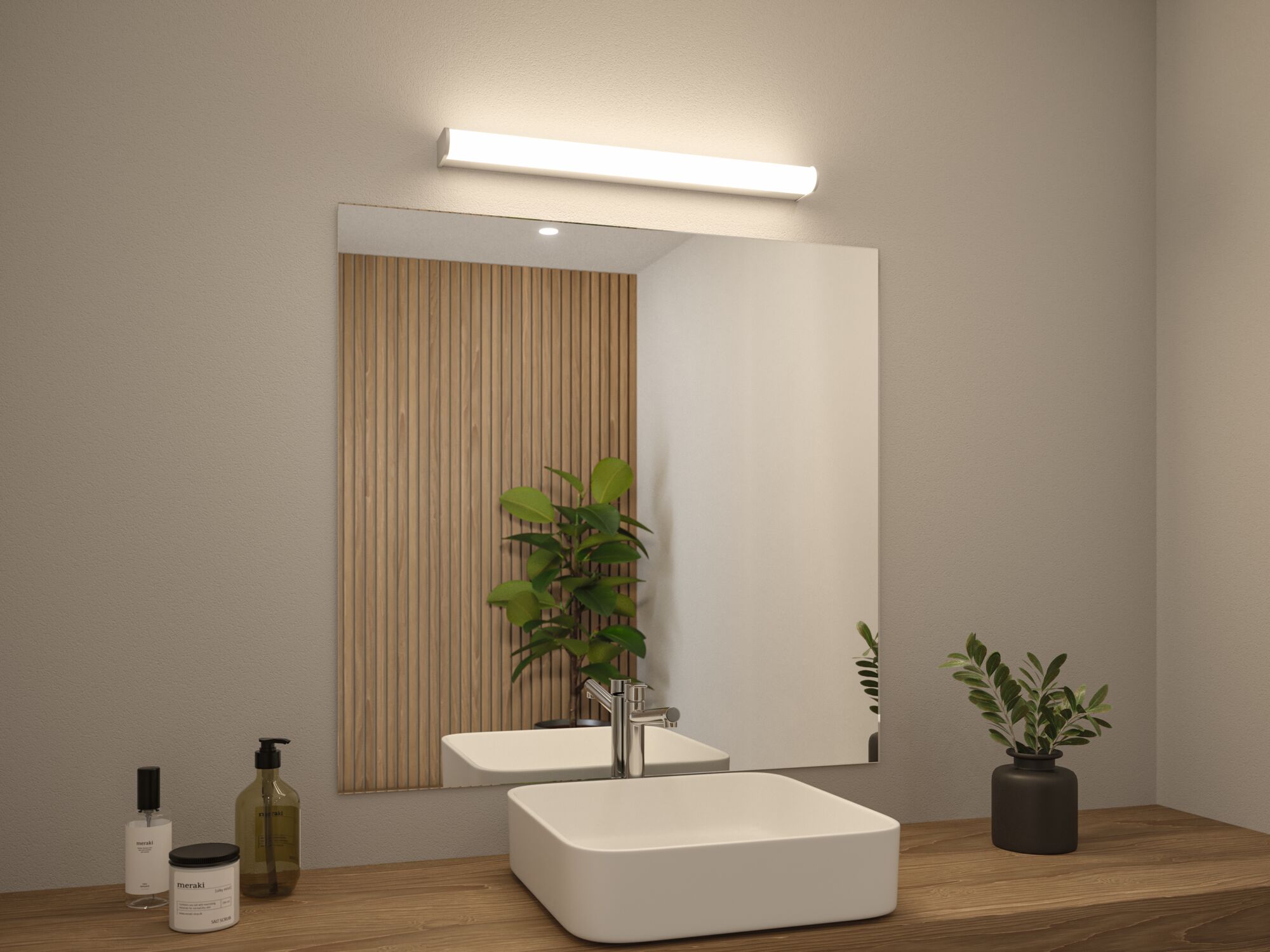 Modern white bathroom sink with stainless steel faucet on wooden countertop, lit mirror and green plant
