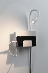 White wall mount with flexible LED reading light and smartphone holder for charging and placement