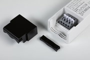 White LED power supply with open terminal block and removed black plastic cover and clamp strip