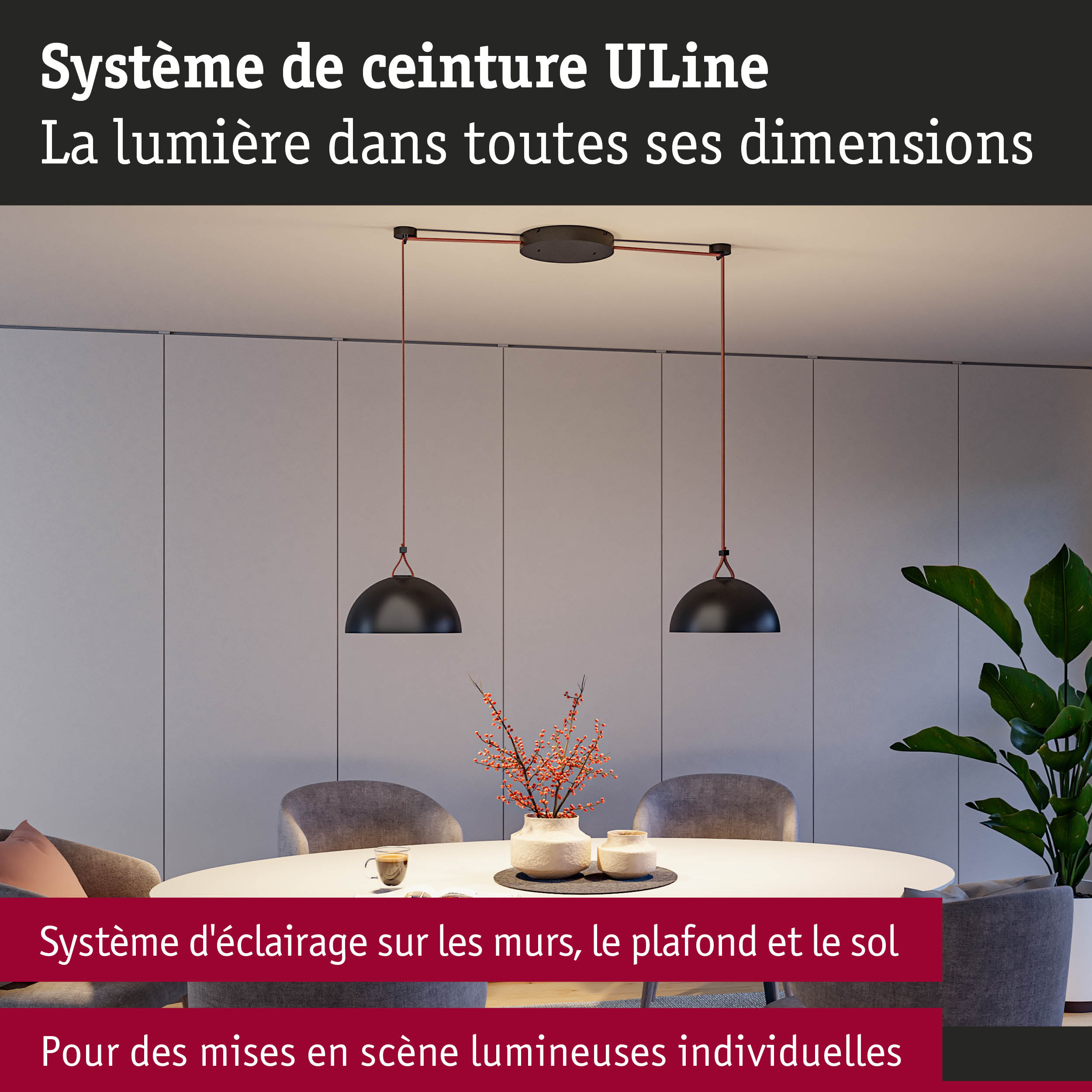 Suspension moderne en métal noir avec câble rouge au-dessus d'une table blanche dans un salon