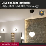 Gove pendant luminaire with warm white LED light and black cord against textured wall