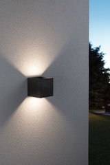 Black aluminum wall light with up and down illumination for outdoor use and modern lighting design.