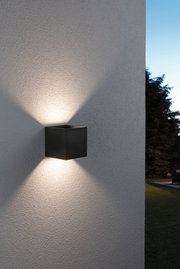 Black aluminum wall light with up and down illumination for outdoor use and modern lighting design.