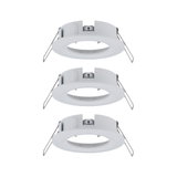 Trois cadres encastrés blancs en plastique avec ressorts métalliques pour lampes LED au plafond.