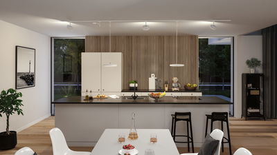 Modern white kitchen with wood panel wall and black countertops, illuminated by LED ceiling spotlights.