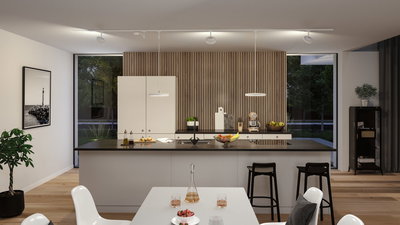Modern white kitchen with wood panel wall and black countertops, illuminated by LED ceiling spotlights.