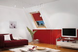 Modern living room with red sofa, white rug, white cable suspension ceiling lights and wooden floor