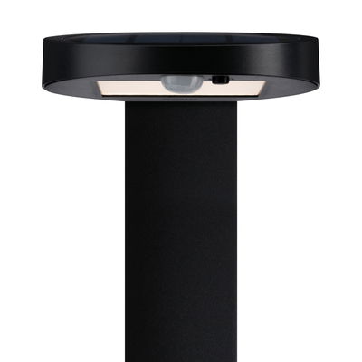 Black solar light with motion sensor and round metal head for outdoor use
