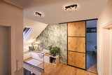 Modern ceiling lights with metal cage and wood accents in cozy living space with wooden floor