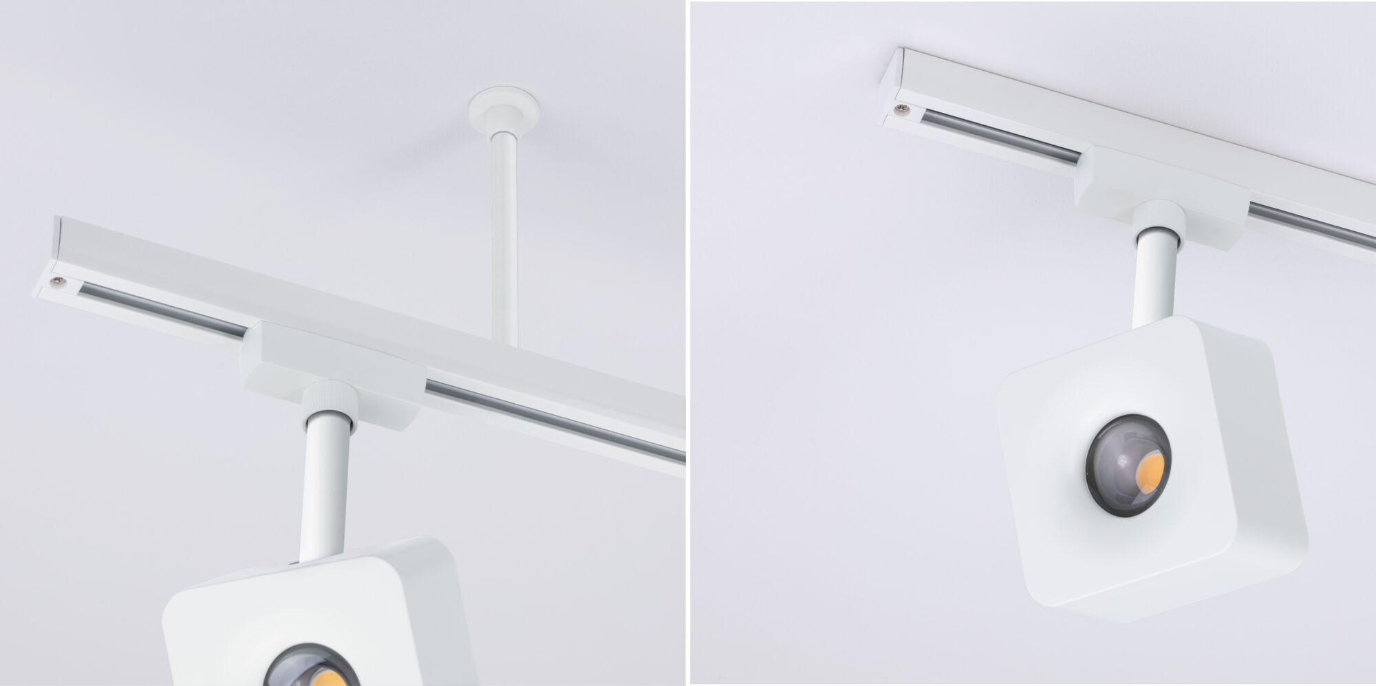 Weißer quadratischer LED-Strahler an weißer Deckenstange mit Schienensystem für moderne Beleuchtung