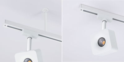 Weißer quadratischer LED-Strahler an weißer Deckenstange mit Schienensystem für moderne Beleuchtung