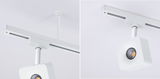 White square LED spotlight on ceiling rod with track system for modern interior lighting