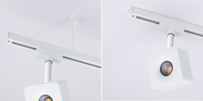 Weißer quadratischer LED-Strahler an weißer Deckenstange mit Schienensystem für moderne Beleuchtung