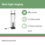 Black floor lamp with glass casing and visible bulb, perfect for modern lighting solutions.