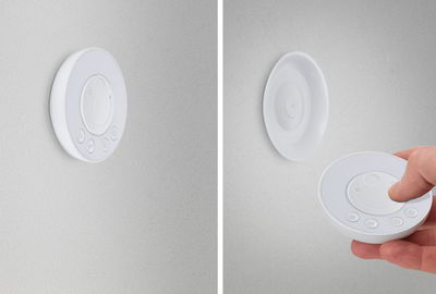 Witte ronde kunststof LED-dimmer aan muur en als afstandsbediening voor lichtregeling