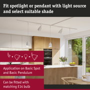 White ceiling lights with spot and pendant options in modern kitchen featuring wood cabinets and window view