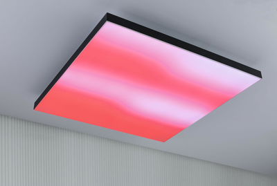 Modern square LED ceiling light with black frame and red gradient, ideal for living spaces.