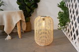 Illuminated round rattan lantern with handle for atmospheric decoration and LED lighting indoors or outdoors.