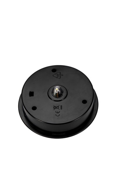 Round black plastic housing with central LED light for lighting systems and fixtures