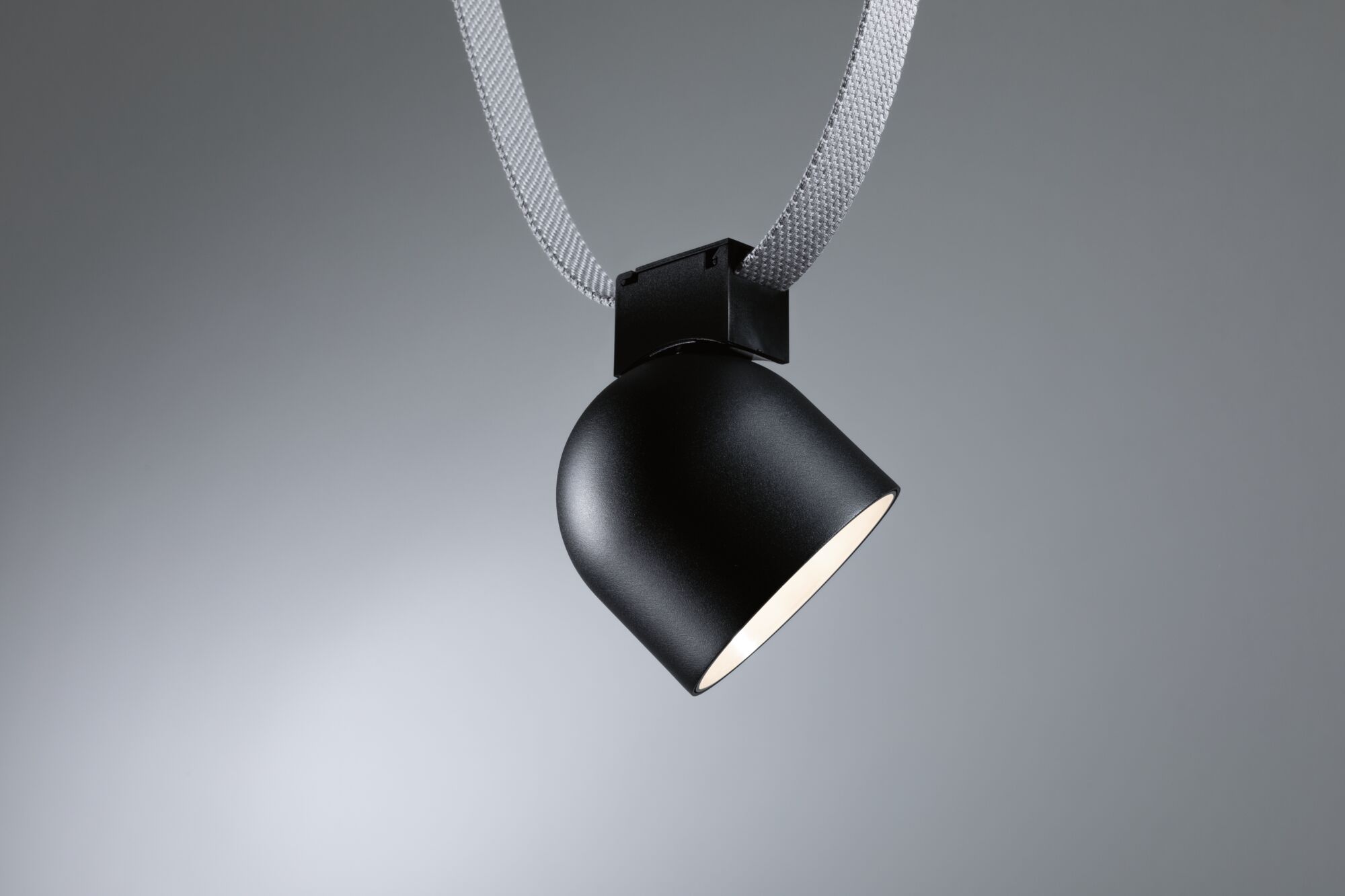 Black metal LED spotlight with white textile cable for modern accent lighting
