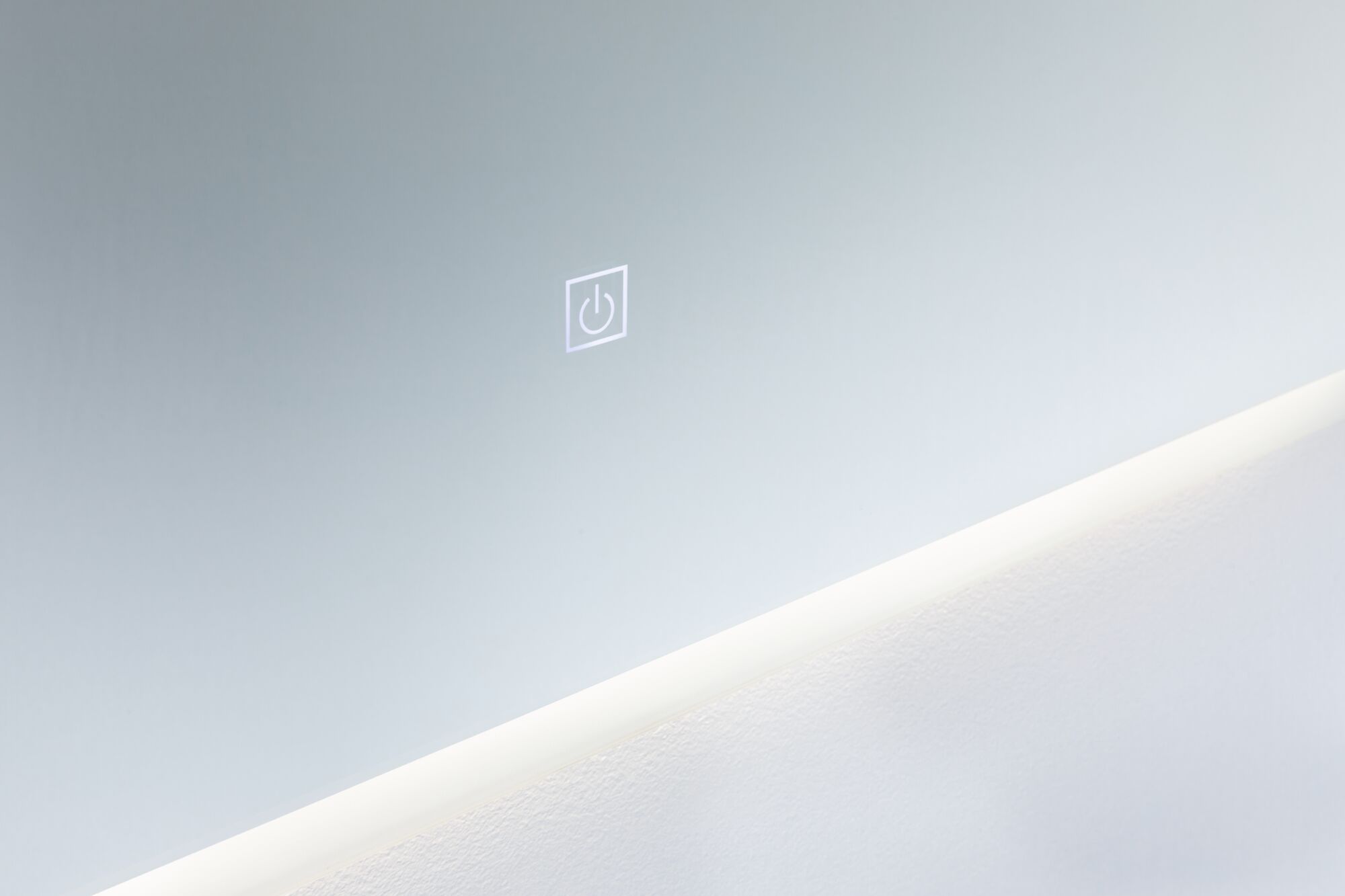 Modern wall mirror with integrated LED light and touch-sensitive power switch in white.