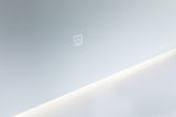 Modern wall mirror with integrated LED light and touch-sensitive power switch in white.