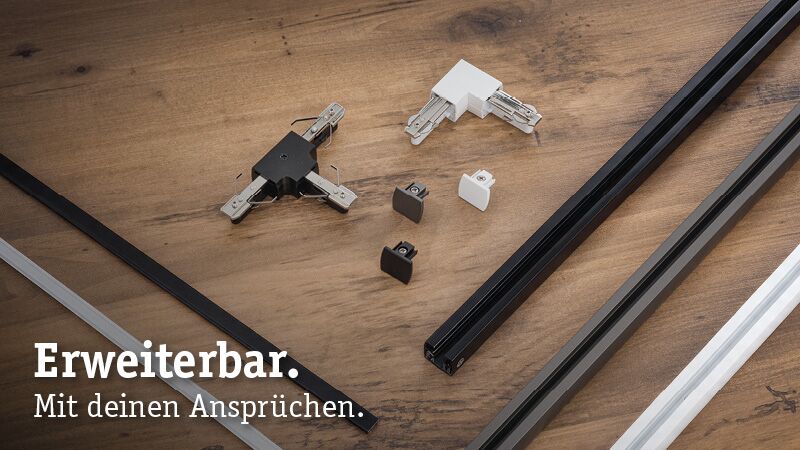 Modulares URail Schienensystem mit schwarzen und weißen Aluminiumprofilen und Verbindern auf Holzuntergrund