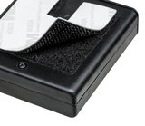 Black plastic case with hook-and-loop fastener and 3M adhesive pad for flexible mounting