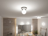 Rund loftlampe med hvidt glas og metalramme i moderne badeværelse med spejl og håndvask.