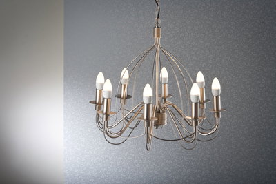 Modern brushed metal chandelier with ten warm white LED candle bulbs for stylish home lighting.