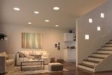 Modern living room with white LED ceiling lights and square wall lamps by the staircase