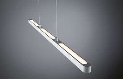 Modern white aluminum LED pendant light with warm white illumination for living and workspaces