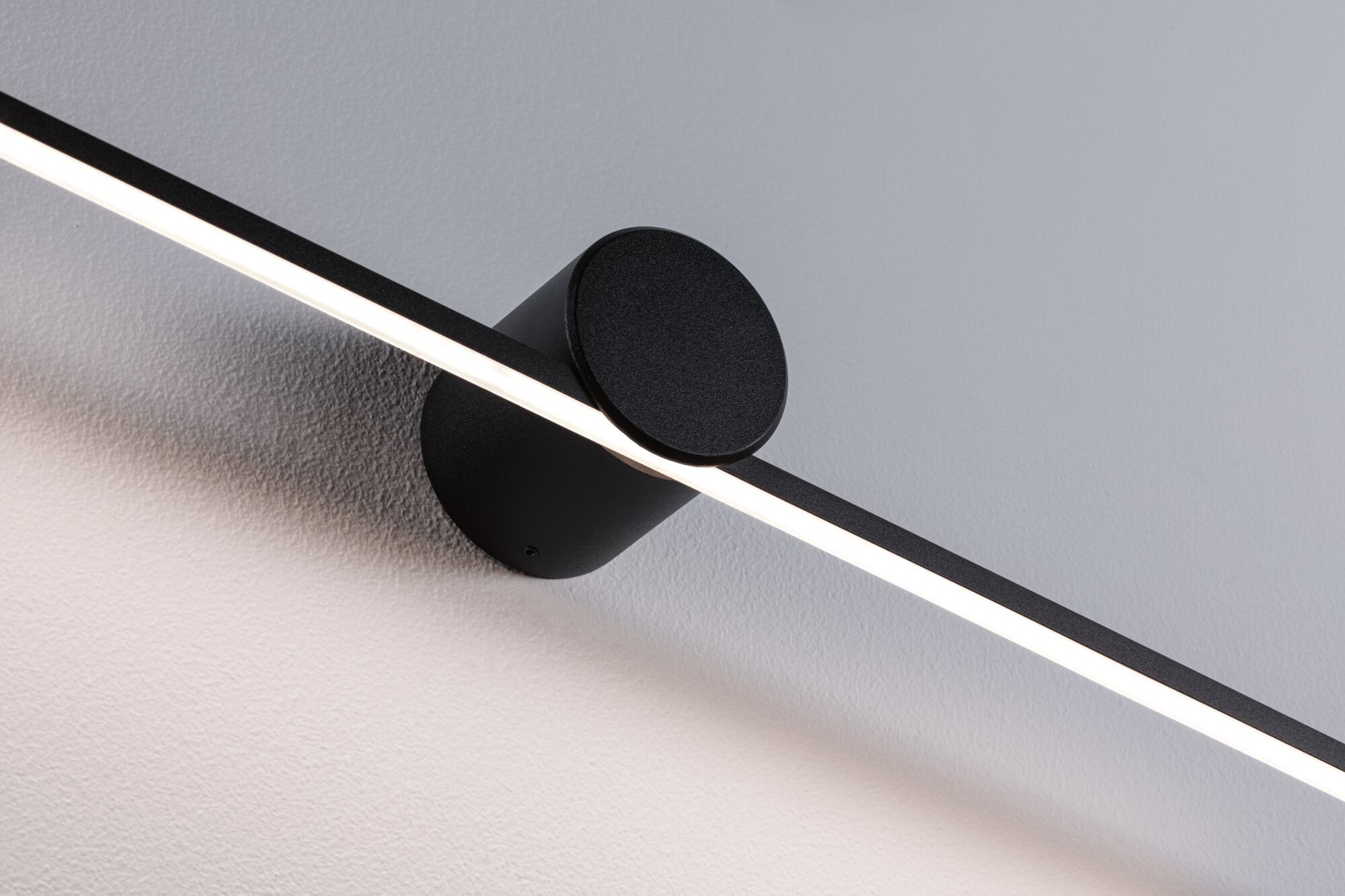 Black metal LED wall light with linear light strip for modern indoor lighting solutions