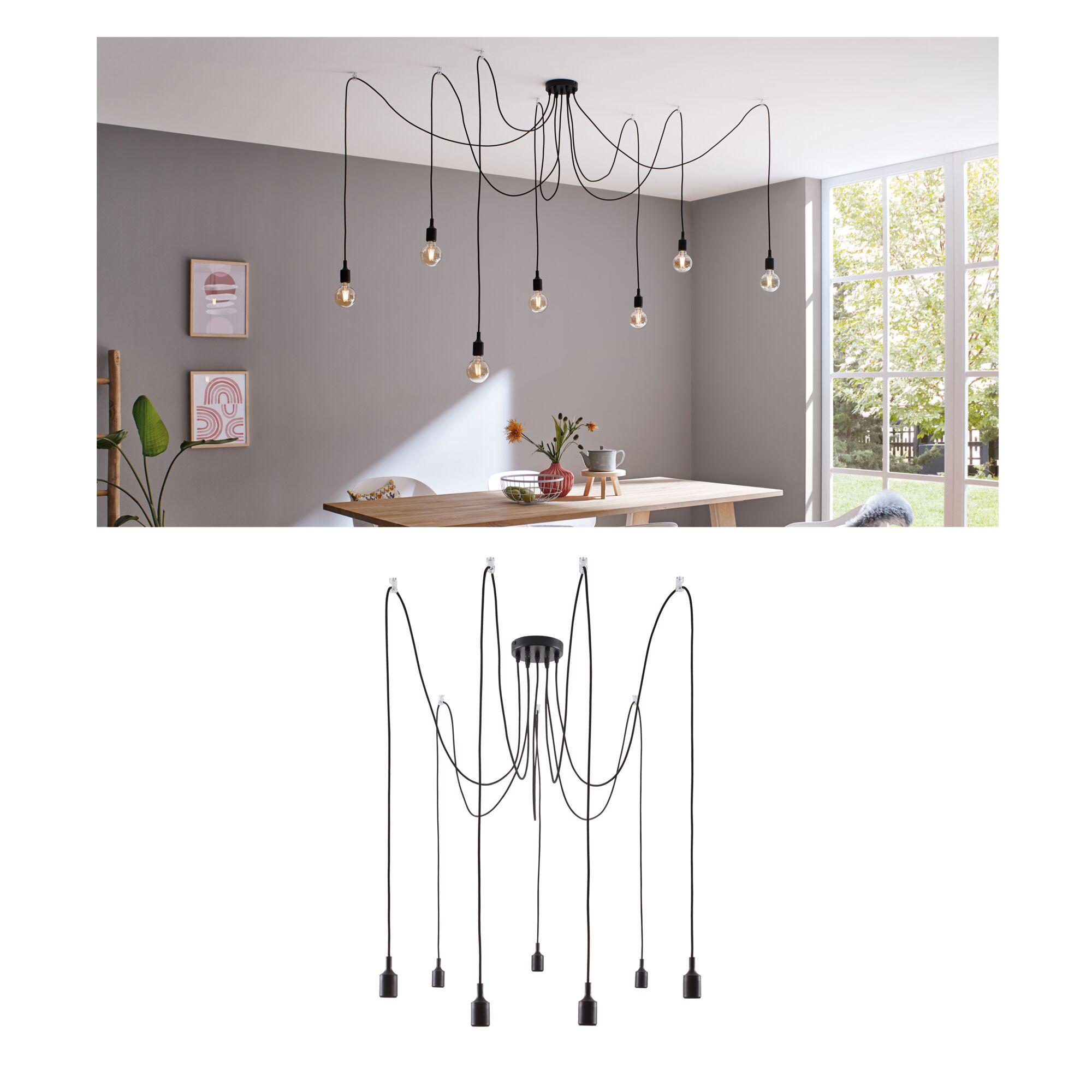 Modern black pendant light with seven bulbs and long cables in bright dining room